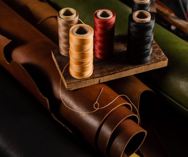 thread-spools-and-needle-placed-on-genuine-brown-l-2026-01-25-01-51-23-utc (1)